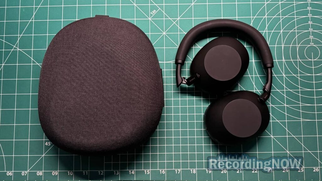 Sony WH-1000XM6 folded and collapsed next to included hardshell case