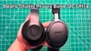Holding Beats Studio Pro vs Bose QuietComfort Ultra side by side in hand