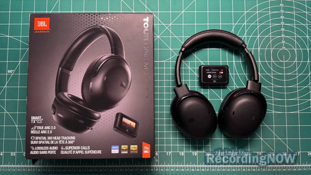 JBL Tour One M3 headphones next to transmitter and original box packaging