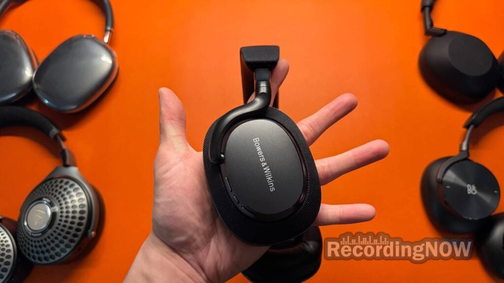 Holding Bowers & Wilkins Px7 S3 with Sony WH-1000XM6, AirPods Max, Focal Bathys, and Bang & Olufsen H95 in background