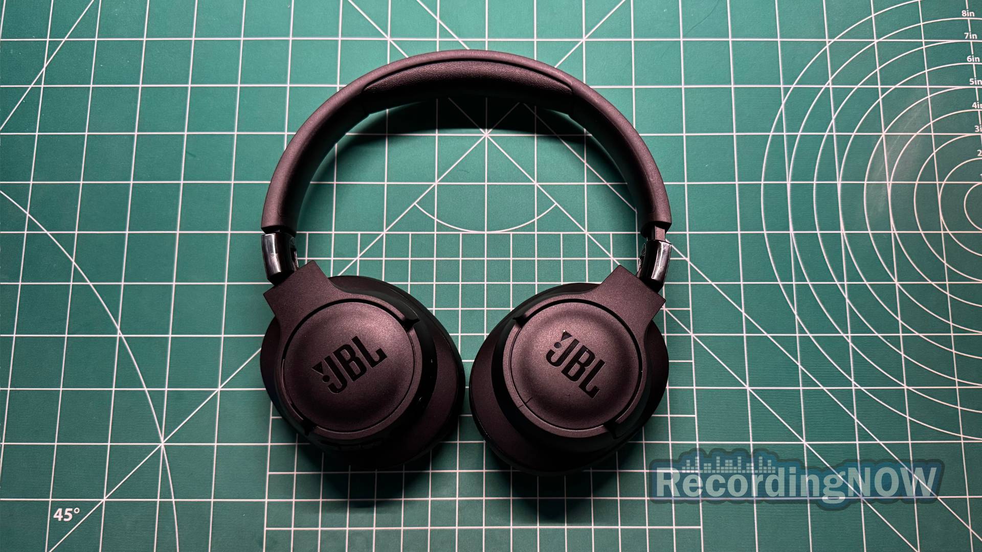 JBL Tune 720BT headphones laid flat on desk