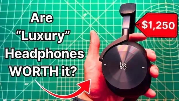 Holding Bang & Olufsen Beoplay H95 headphones in hand