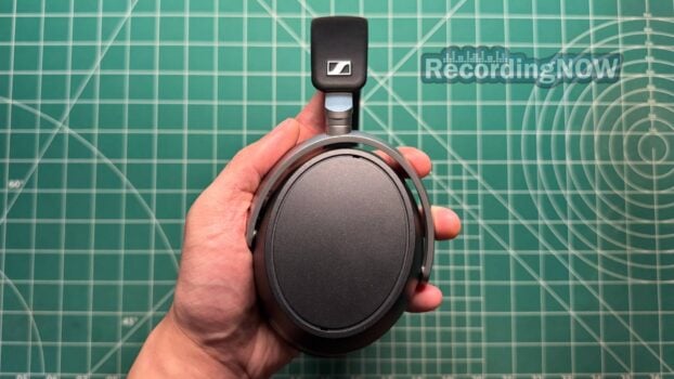 Holding Sennheiser HDB 630 headphones in hand