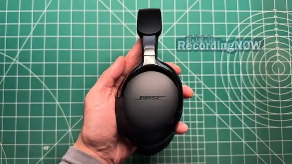 Holding Bose QuietComfort Ultra 2nd gen headphones in hand