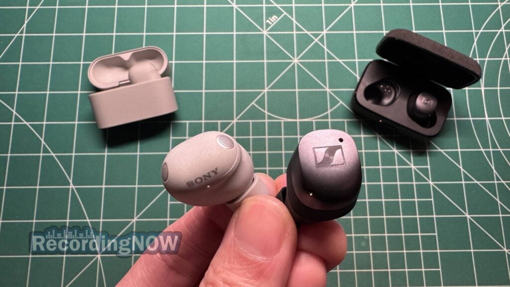 Holding Sony WF-1000XM6 earbuds next to Sennheiser Momentum True Wireless 4 in hand