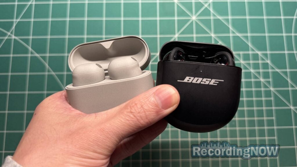 Holding Sony WF 1000XM6 and Bose QuietComfort Ultra Earbuds 2nd gen in hand