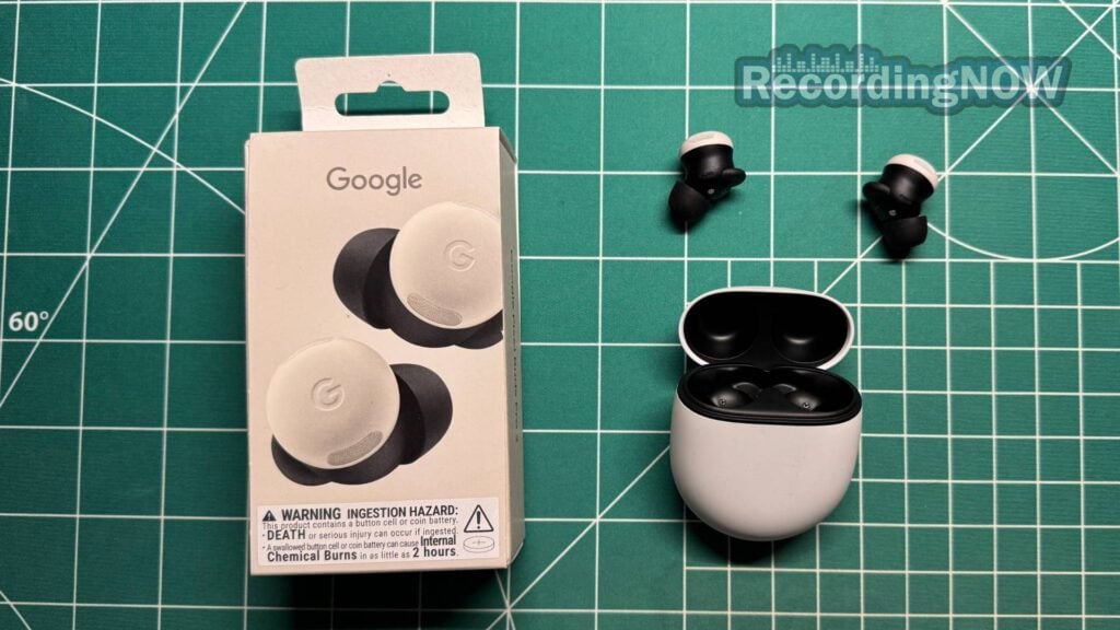 Google Pixel Buds Pro 2 earbuds next to charging case and original box packaging