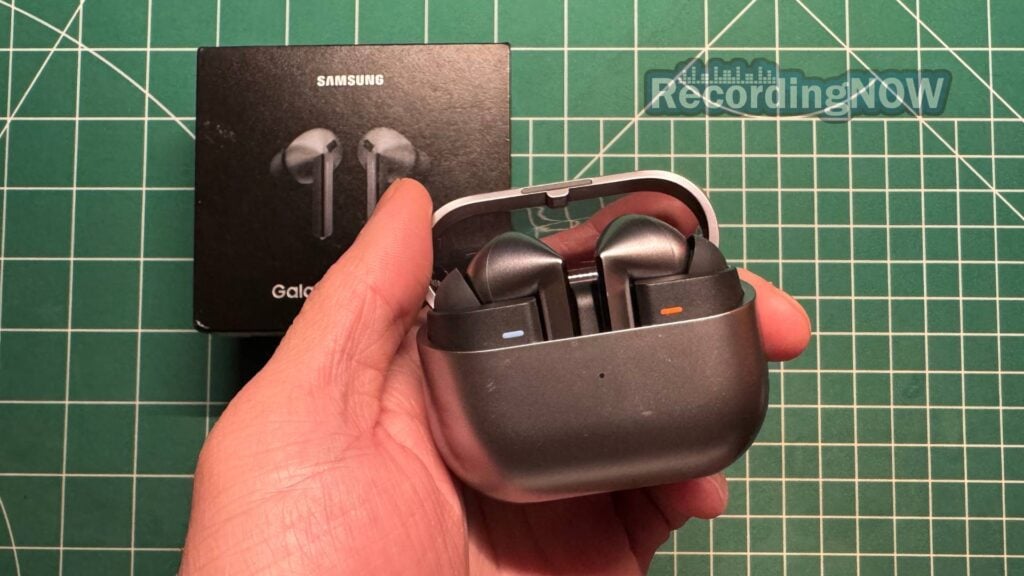 Holding Samsung Galaxy Buds3 Pro Silver wireless noise cancelling earbuds in hand