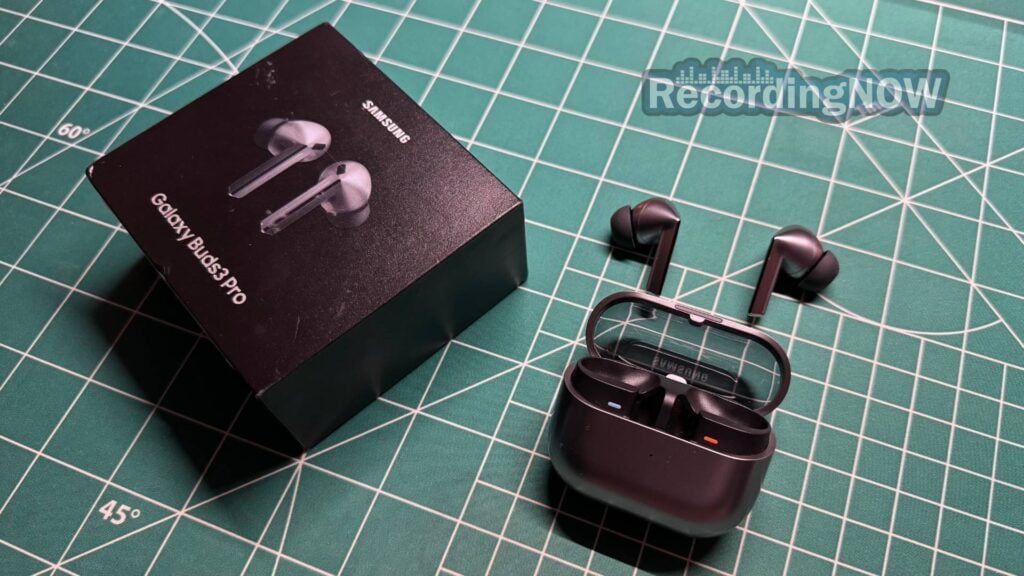 Samsung Galaxy Buds 3 Pro earbuds and charging case next to original box packaging