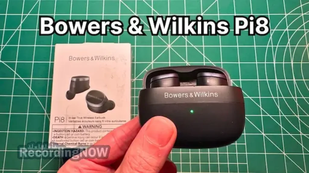 Holding Bowers & Wilkins Pi8 wireless noise cancelling earbuds in hand