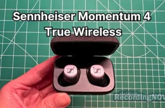 Holding Sennheiser Momentum True Wireless 4 earbuds in hand