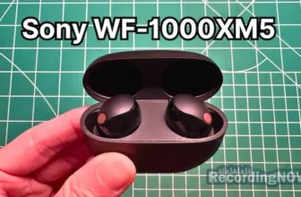 Holding Sony WF-1000XM5 wireless noise cancelling earbuds in hand