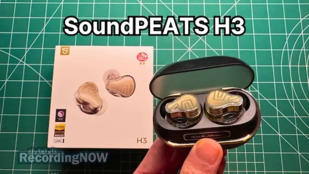 Holding SoundPEATS H3 wireless noise cancelling earbuds in hand