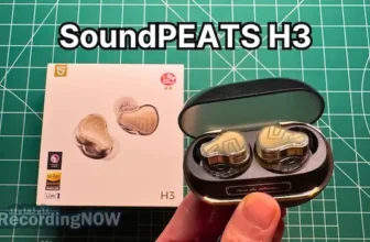 Holding SoundPEATS H3 wireless noise cancelling earbuds in hand