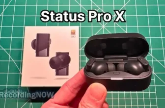 Holding Status Pro X wireless noise cancelling earbuds in hand