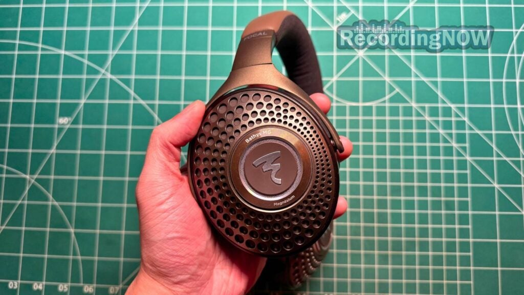 Holding Focal Bathys MG headphones in hand