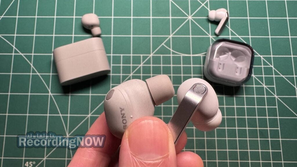 Holding Sony WF-1000XM6 earbuds next to Samsung Galaxy Buds4 Pro earbuds