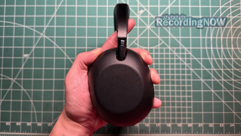 Holding earcup of Sony 1000X THE COLLEXION headphones in hand