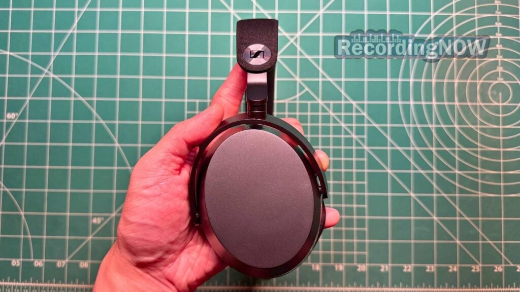 Holding earcup of Sennheiser Momentum 5 headphones in hand