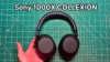 holding Sony 1000X THE COLLEXION headphones in hand