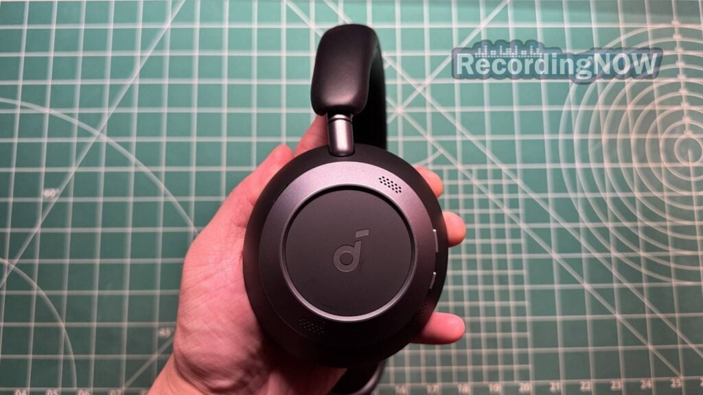 Holding Earcup of Anker Soundcore Space One Pro headphones in hand