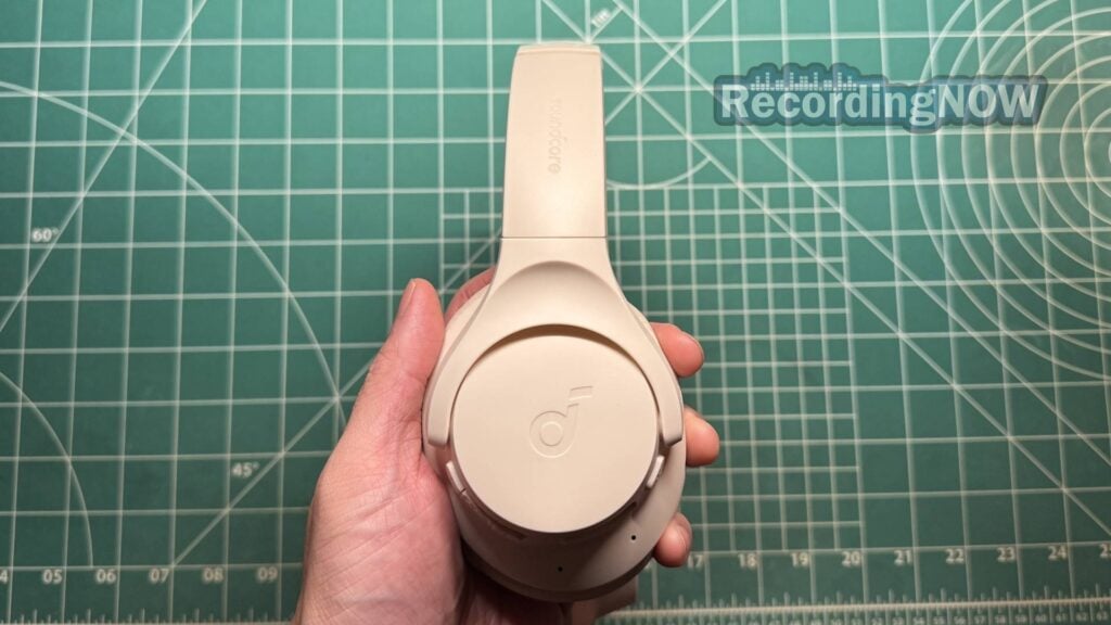 Holding Anker Soundcore Q20i wireless noise cancelling headphones in hand