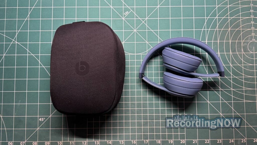 Beats Solo 4 in folded position next to included softshell case