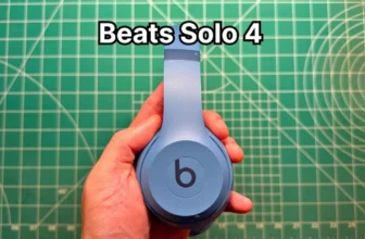 Holding Beats Solo 4 wireless on-ear headphones in blue in hand