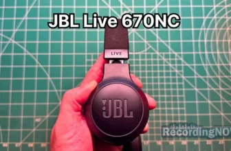 Holding JBL Live 670NC wireless noise cancelling on-ear headphones in hand