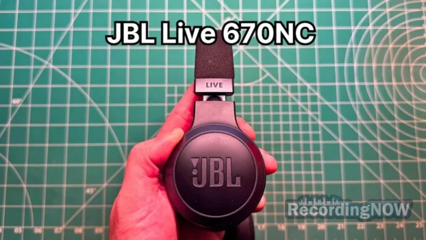 Holding JBL Live 670NC wireless noise cancelling on-ear headphones in hand