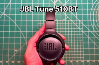 Holding JBL Tune 510BT wireless on-ear headphones in hand