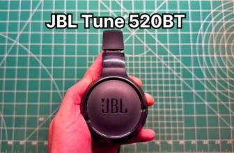 Holding JBL Tune 520BT wireless on-ear headphones in hand