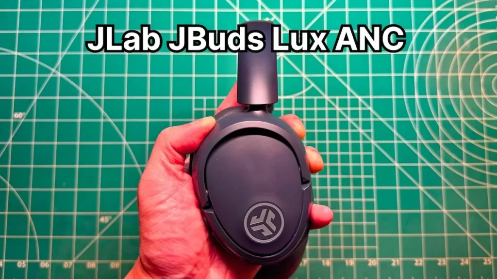 Holding JLab JBuds Lux ANC wireless noise cancelling headphones in hand