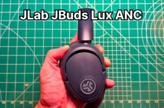 Holding JLab JBuds Lux ANC wireless noise cancelling headphones in hand