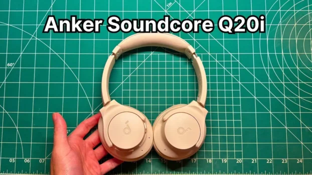 Holding Anker Soundcore Q20i wireless noise cancelling headphones in hand