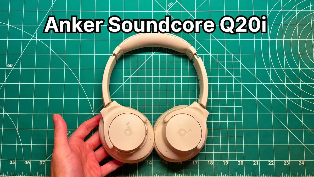 Holding Anker Soundcore Q20i wireless noise cancelling headphones in hand