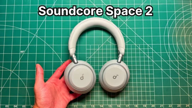 Holding Anker Soundcore Space 2 headphones in Seafoam Green in hand