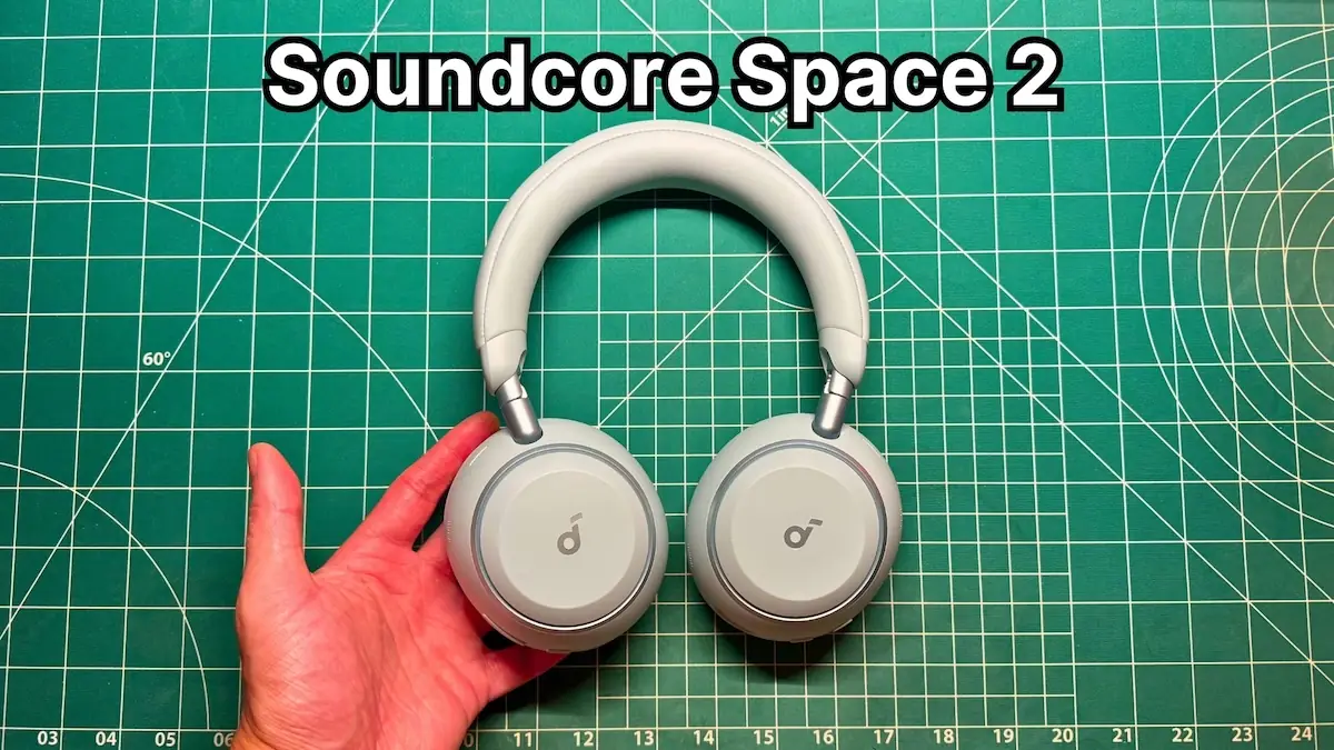 Holding Anker Soundcore Space 2 headphones in Seafoam Green in hand