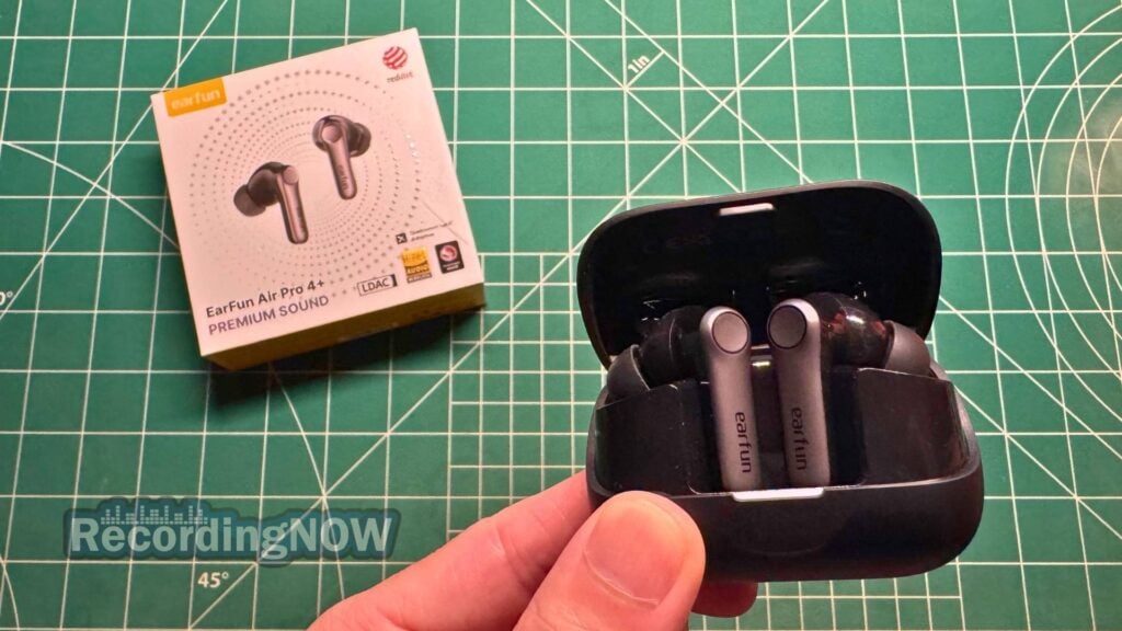 Holding EarFun Air Pro 4+ wireless earbuds inside charging case