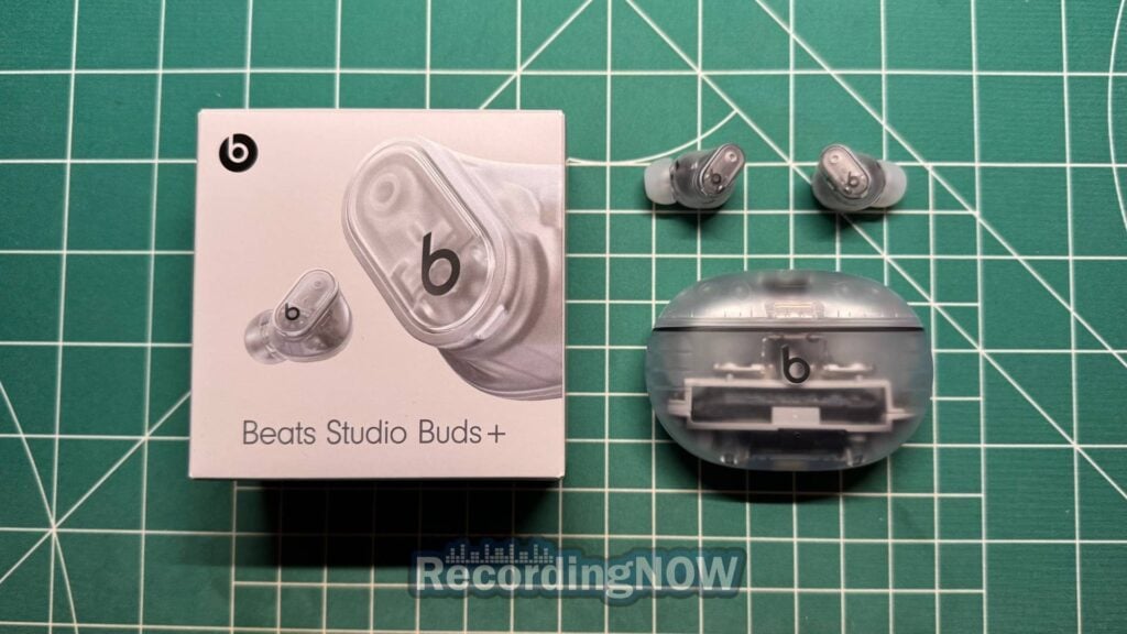 Beats Studio Buds + in Transparent next to original box packaging