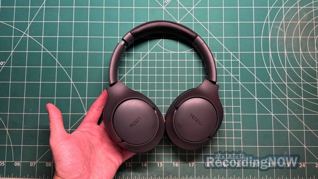 Holding TOZO HT3 wireless noise cancelling headphones