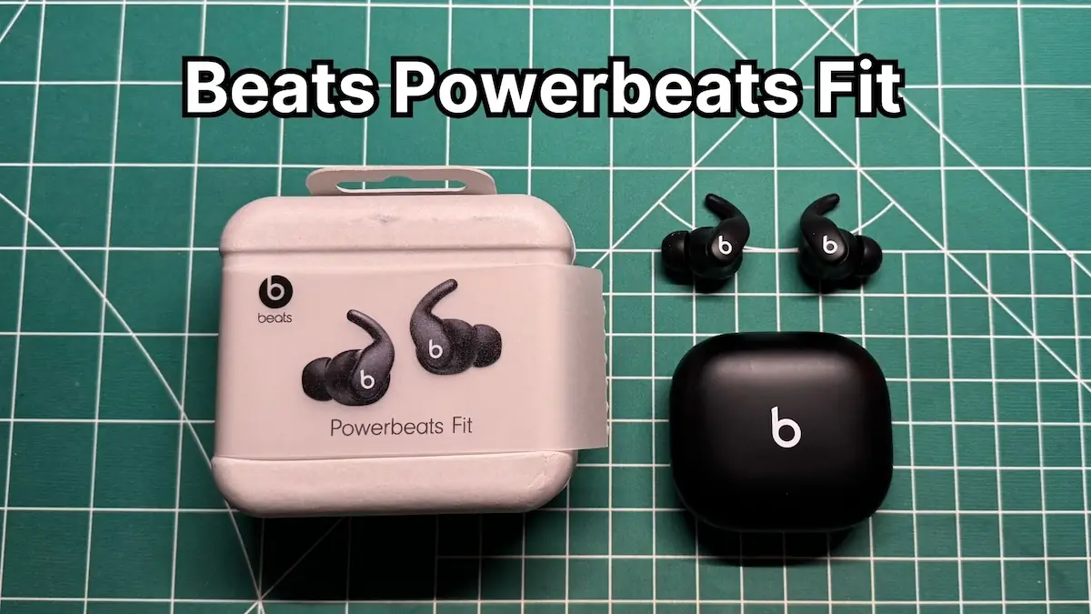 Beats Powerbeats Fit wireless noise cancelling earbuds next to original box packaging