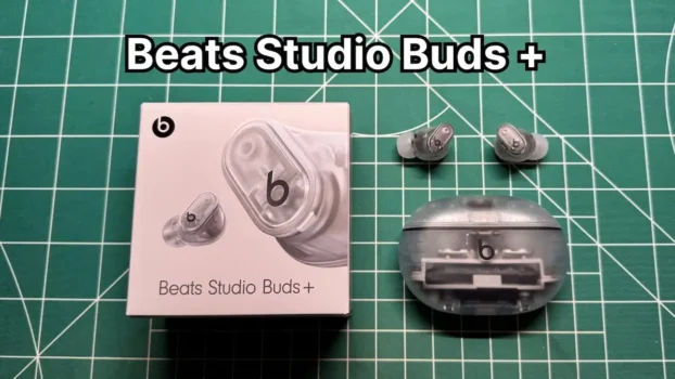 Beats Studio Buds Plus + wireless noise cancelling earbuds in Transparent color next to original box packaging