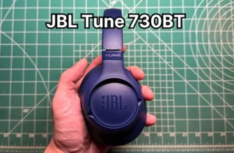 Holding JBL Tune 730BT wireless headphones in hand