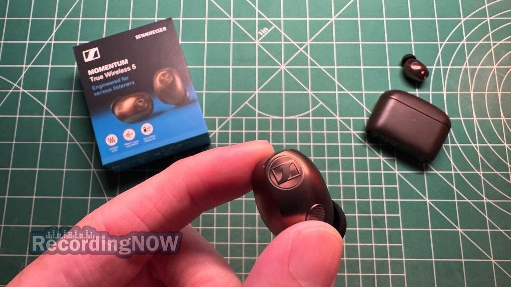 blog-img-1693067280109 Holding Sennheiser Momentum True Wireless 5 noise cancelling earbuds in hand