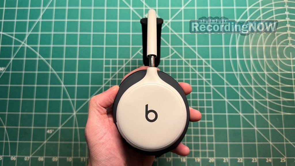 Holding earcup of Beats 360 headphones in hand