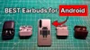 Samsung Galaxy S23 Smartphone next to several wireless noise cancelling earbuds