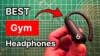 Holding Beats Powerbeats Pro 2 earbuds in hand