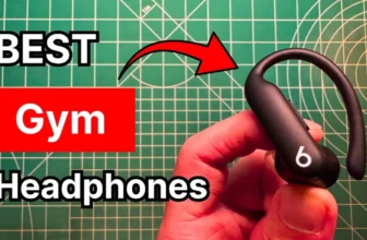 Holding Beats Powerbeats Pro 2 earbuds in hand