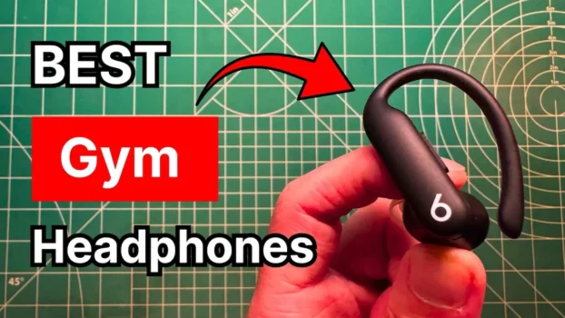 Holding Beats Powerbeats Pro 2 earbuds in hand